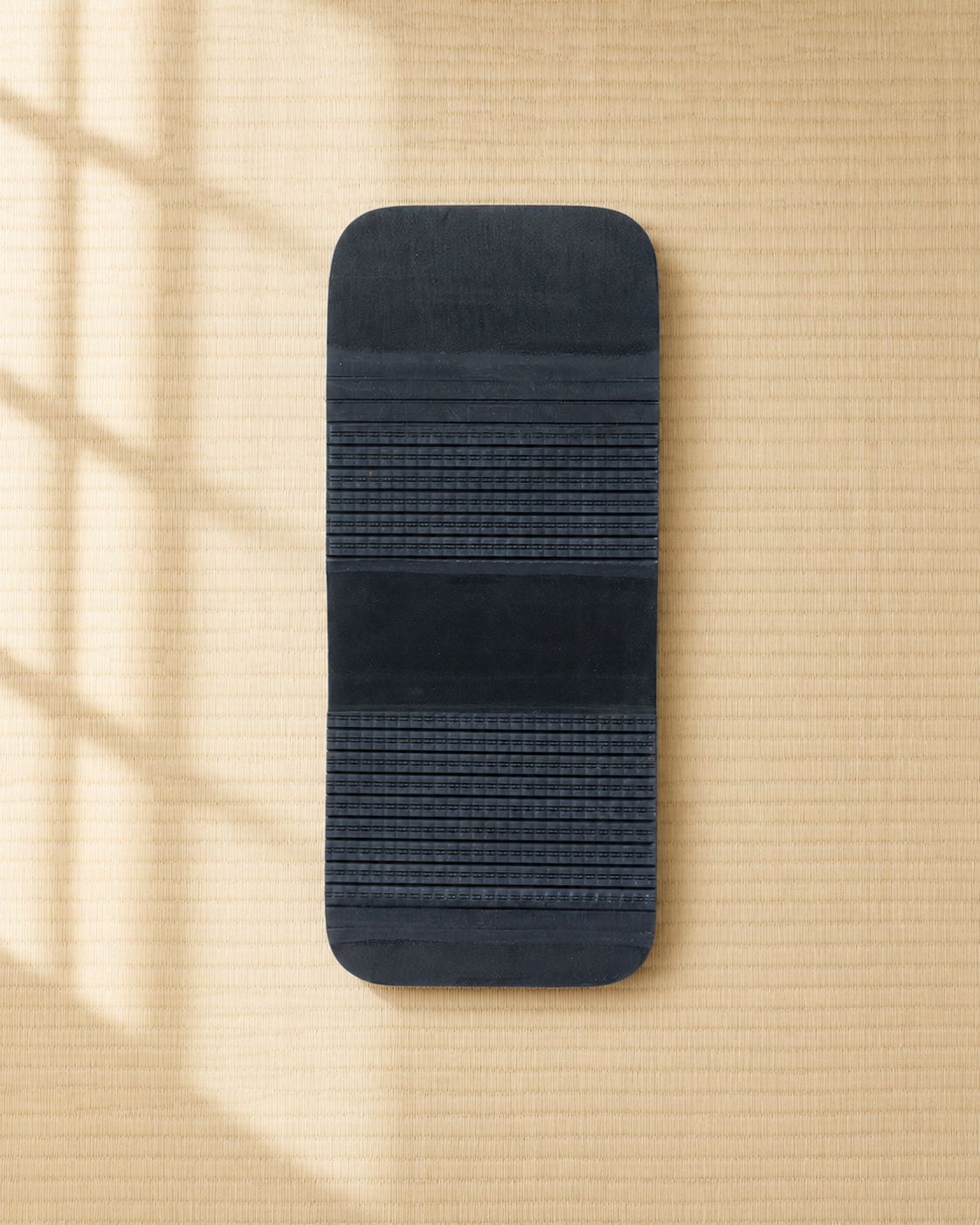 The outsole — two ribbed traction fields with a smooth arch band between them