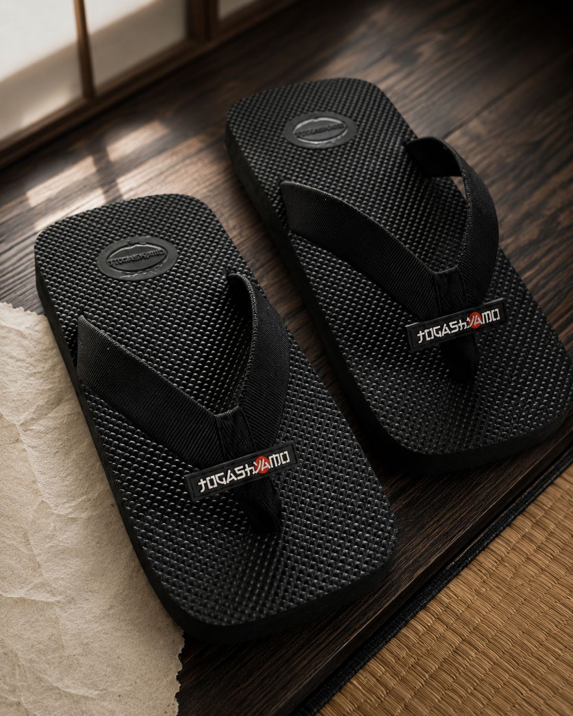 A pair resting on dark timber beside washi and tatami